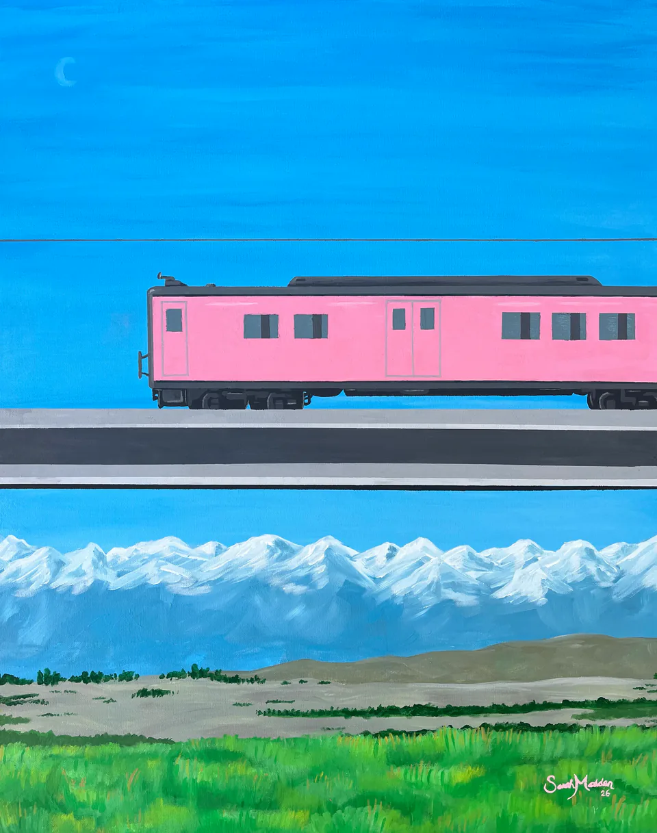 A pink passenger train crossing a wide green plain under a vivid blue sky, with a line of snow-capped mountains behind.