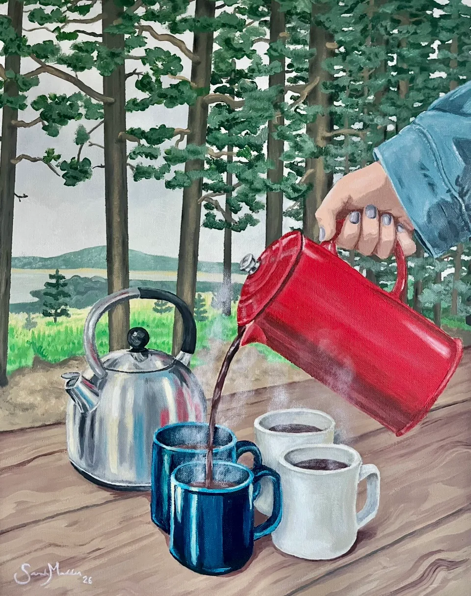 A hand pouring coffee from a red thermos into waiting mugs beside a steel kettle on a weathered picnic table, tall pines behind.