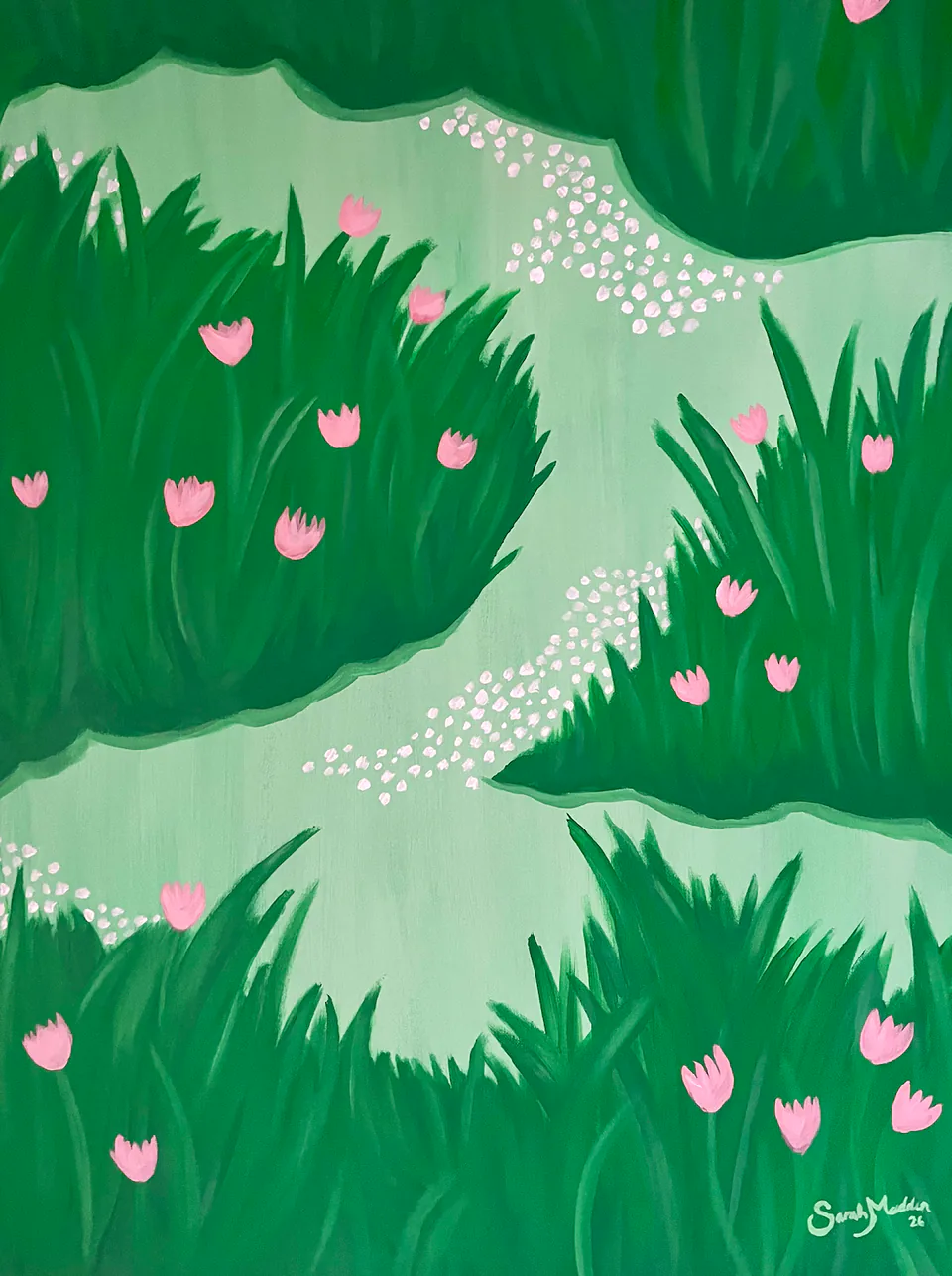 A green meadow scattered with pink tulips and small white blossoms, a pale path winding through it.