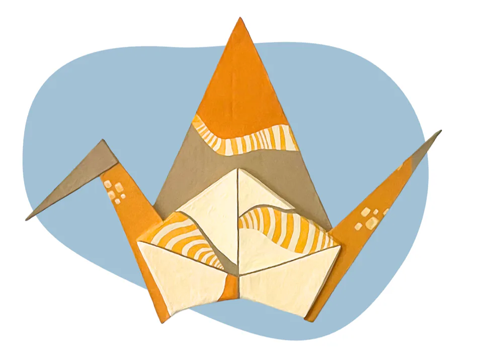 A folded paper sculpture with long pointed orange and white wings, on a pale blue backdrop.