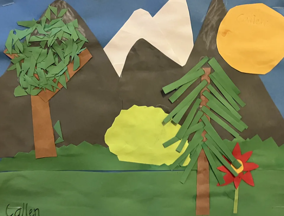 A paper collage landscape with a small house among evergreen trees and layered mountains.